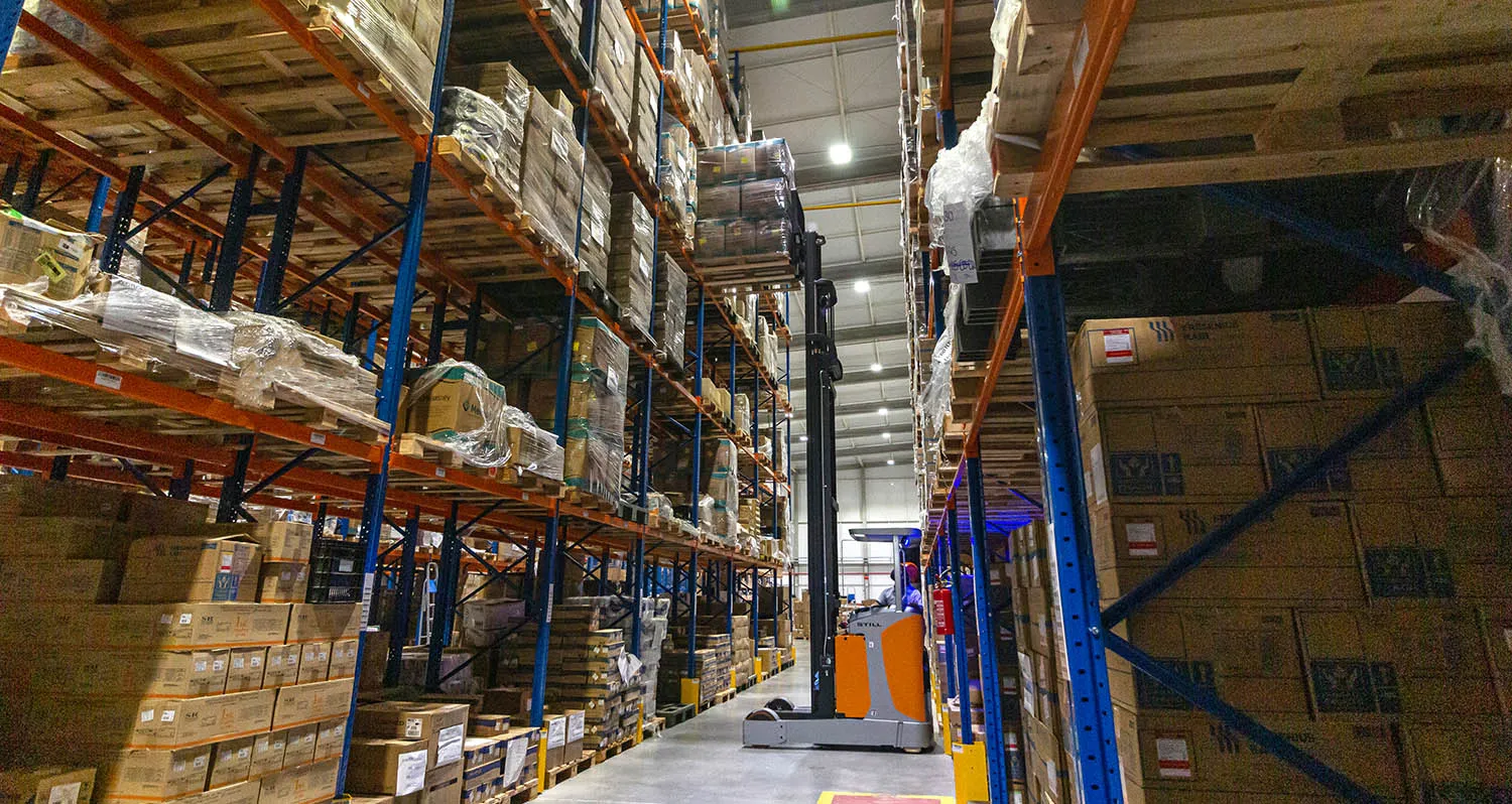 Internal aisle of the Altermed warehouse with forklift
